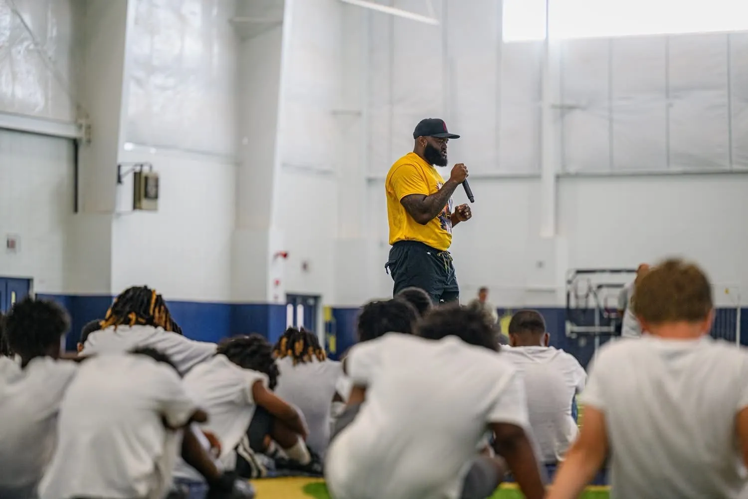 Austin addressing Camp AB participants inside the football facility