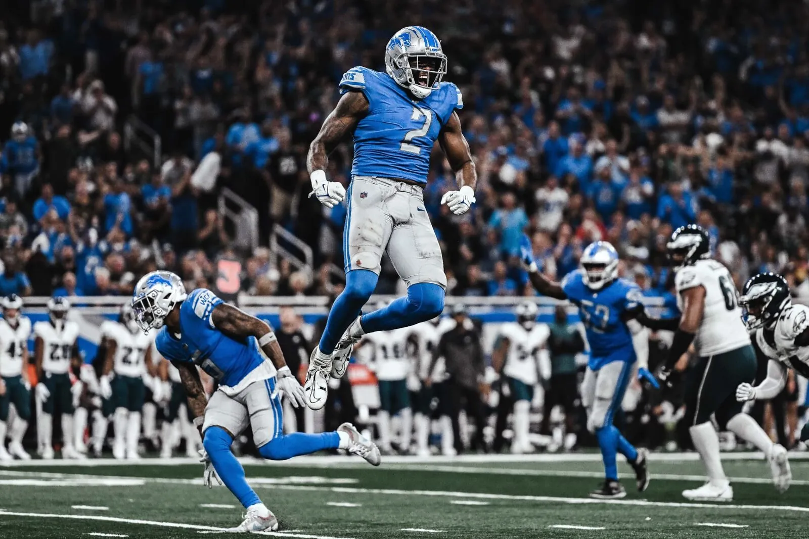 Austin Bryant celebrating mid-air for the Detroit Lions