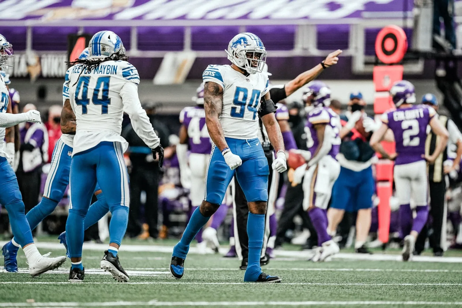 Austin Bryant wearing number 94 on the field with Detroit Lions teammates