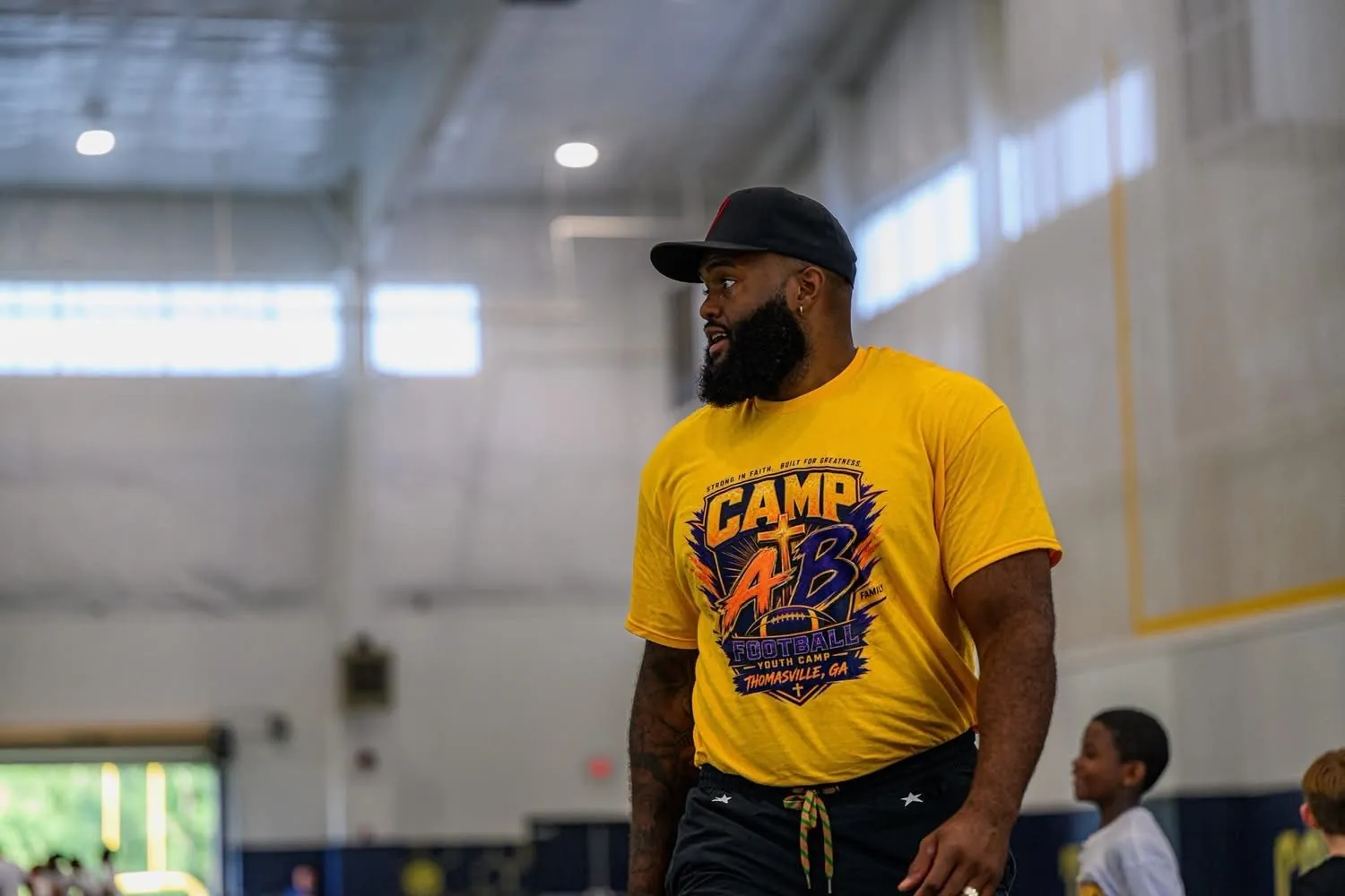 Austin Bryant in his yellow Camp AB shirt at the youth football camp